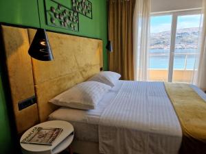 a bedroom with a large bed with a window at Boutique Villa Revelin in Pag