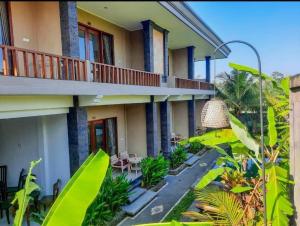 a building with a bunch of plants in front of it at Pulu Sari Suite Ubud in Ubud