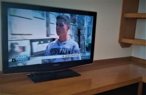 a flat screen tv sitting on top of a wooden table at Studio 6 in Warsaw