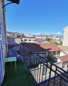 a balcony with a green bench on a building at Le Payan in Gap