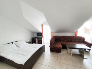 a living room with a couch and a bed at Apartments Prajo, Orebić in Orebić