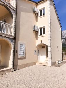 a large building with two arches and a door at Apartments Prajo, Orebić in Orebić