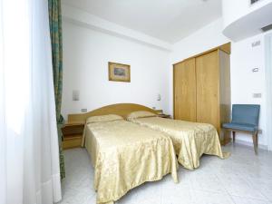 Postel nebo postele na pokoji v ubytování Hotel Reginella