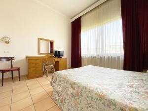 Postel nebo postele na pokoji v ubytování Hotel Reginella