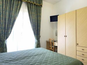 Postel nebo postele na pokoji v ubytování Hotel Reginella