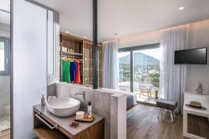 a bathroom with a sink and a large window at Blue Senses Villas in Agios Nikolaos