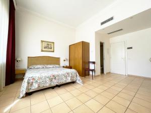 Postel nebo postele na pokoji v ubytování Hotel Reginella