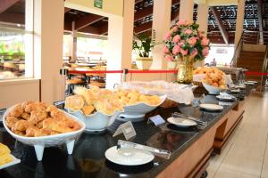 a buffet line with various types of pastries in bowls at HotSprings OFICIAL B3 Hotéis in Caldas Novas