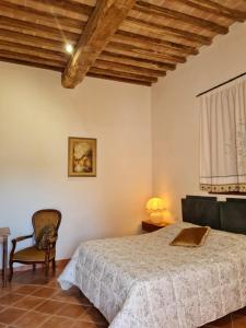 a bedroom with a bed and a chair at Agriturismo IL Paradiso di Berignone in Caprareccia +61 photos
