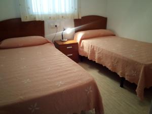 Postel nebo postele na pokoji v ubytování APCOSTAS Marina D'or 2da Línea