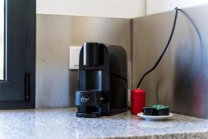 a coffee maker sitting next to a red candle at Casa da Cerca - Picadeiro 2 in Vieira do Minho