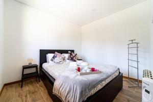a bedroom with a bed with a tray on it at Casa da Cerca - Picadeiro 2 in Vieira do Minho