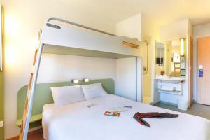 a bedroom with a bunk bed with a ladder at IBIS BUDGET Biarritz - Anglet in Anglet