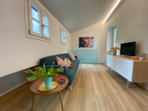 a living room with a blue couch and a table at Sweet Dreams in Cannobio
