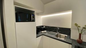 a small kitchen with a sink and a counter at Sweet Dreams in Cannobio +58 photos