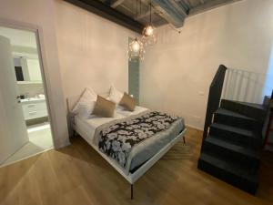 a bedroom with a bed with pillows and a staircase at Sweet Dreams in Cannobio