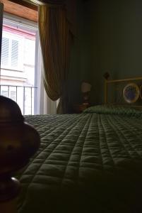 a bedroom with a large bed with a window at Appartamento Baldo 13 in Perugia