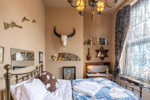 a bedroom with a bed and a skull on the wall at La Rosa Hotel in Whitby