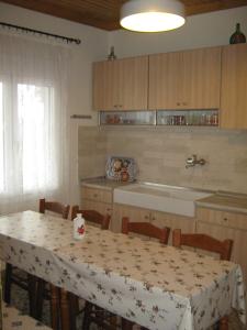 a kitchen with a table with a table cloth on it at George house in Theológos