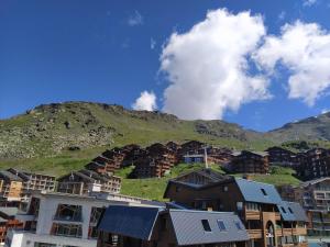 a group of houses in front of a mountain at Cimes De Caron Appartements VTI in Val Thorens