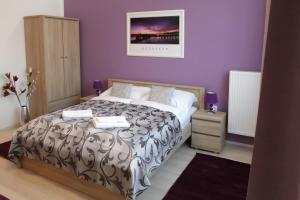 A bed or beds in a room at ABT Apartments Karoly