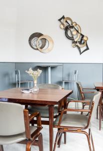 a dining room with a wooden table and chairs at Hotel Don Carmelo in Avila