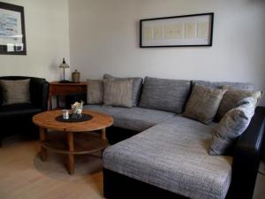 a living room with a couch and a table at Fliegender Holländer in Juist