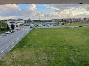 a view of a city street with a grass field at Oceania apartments in Grosseto