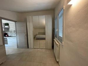 a room with a hallway with a television and a bedroom at Oceania apartments in Grosseto