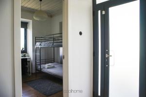 a door leading to a bedroom with a bunk bed at 12 Casa d'Avó in Albergaria-a-Velha