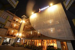 a building with a lit up facade at night at The Phoenix Residency in Shillong