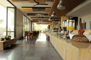 a restaurant with a long counter with a bar at Paragon Hotel Seminyak in Seminyak +42 photos