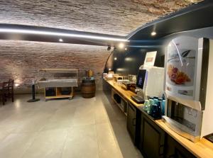 a room with a kitchen with a counter with a coffee maker at Kyriad Chalon-Sur-Saone Centre in Chalon-sur-Saône