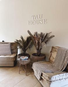 a living room with two couches and a sign saying tax house at Tau House in Guatapé