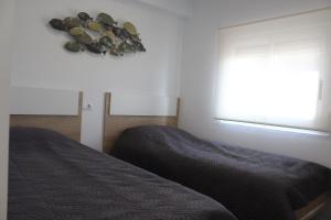 a bedroom with two beds and a window at Calpe Beachview in Calpe