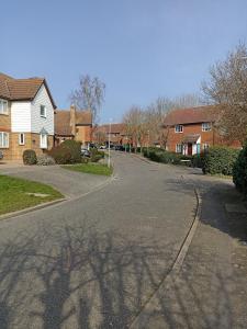 an empty street in a residential neighborhood with houses at Froden Court in Billericay