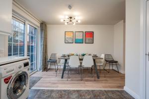 a kitchen and dining room with a table and chairs at Central Belfast Apartments: Ashley Mews in Belfast