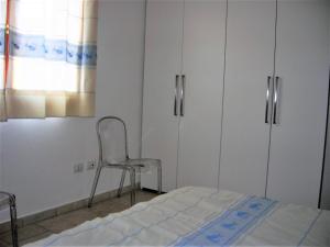 A bed or beds in a room at Appartamento nel cuore di Villasimius 1 piano