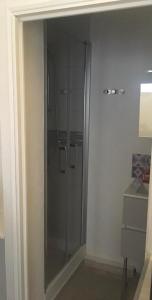 a bathroom with a glass shower in a room at Studio Cosy à Orange in Orange