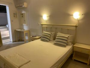 a bedroom with a large bed with two pillows at Nikoletta Studios in Agios Prokopios