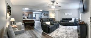 a living room with a couch and chairs and a table at The Cottage House on the Blue Mile - Family Friendly, Close to GSU! in Statesboro
