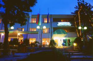 a building at night with lights in front of it at Paradise Hotel in Madzharovo