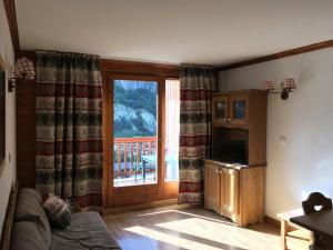 uma sala de estar com uma porta de vidro deslizante e uma varanda em Appartement Valloire, 2 pièces, 4 personnes - FR-1-263-454 em Valloire