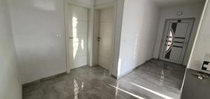 an empty room with white walls and a door at Apartmani Naomi&Leo in Senj