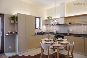 a kitchen with a table and chairs in a room at 14 Calçada de Santiago in Vila do Conde