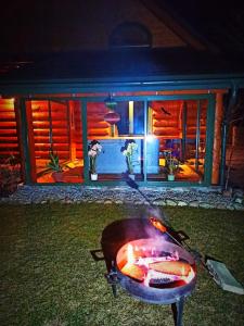 a grill in front of a house at night at Willa Siemianówka - Sauna, Jacuzzi in Rybaki