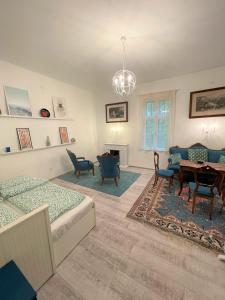 a living room with a couch and a table at Villa Bagolyvár in Balatonszemes