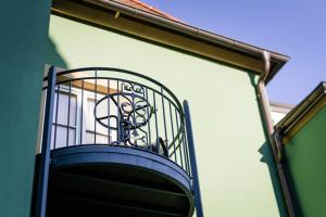 a bird cage on the side of a building at Hotel Belle Vue Volkach in Volkach