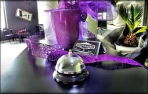 a table with a purple ribbon and a bell on it at Prytaneio Design Hotel in Dodoni