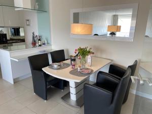 a kitchen with a table with chairs and a dining room at Top - Apartment mit Aussicht in Timmendorfer Strand